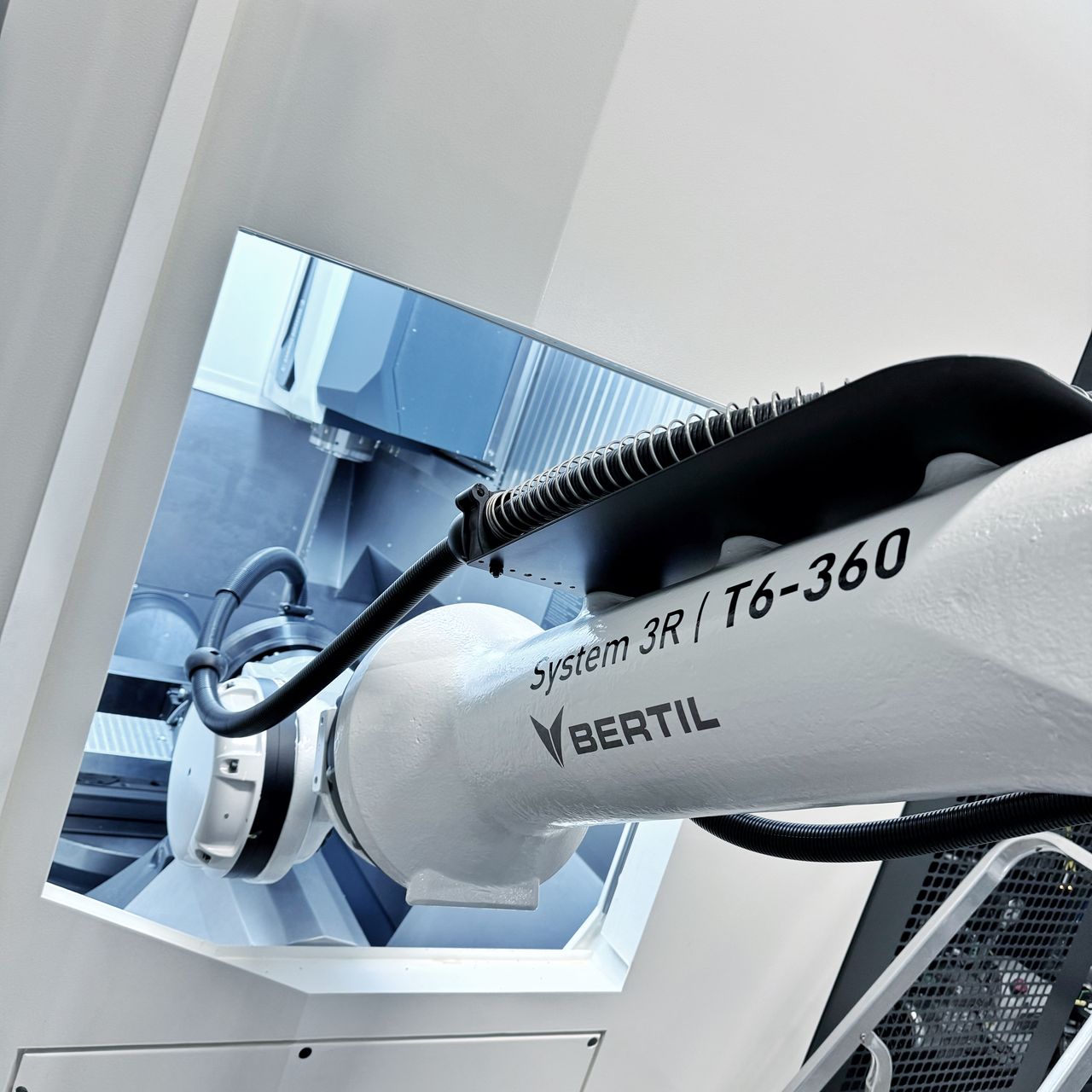 Robotic loading equipment beside a CNC machining centre